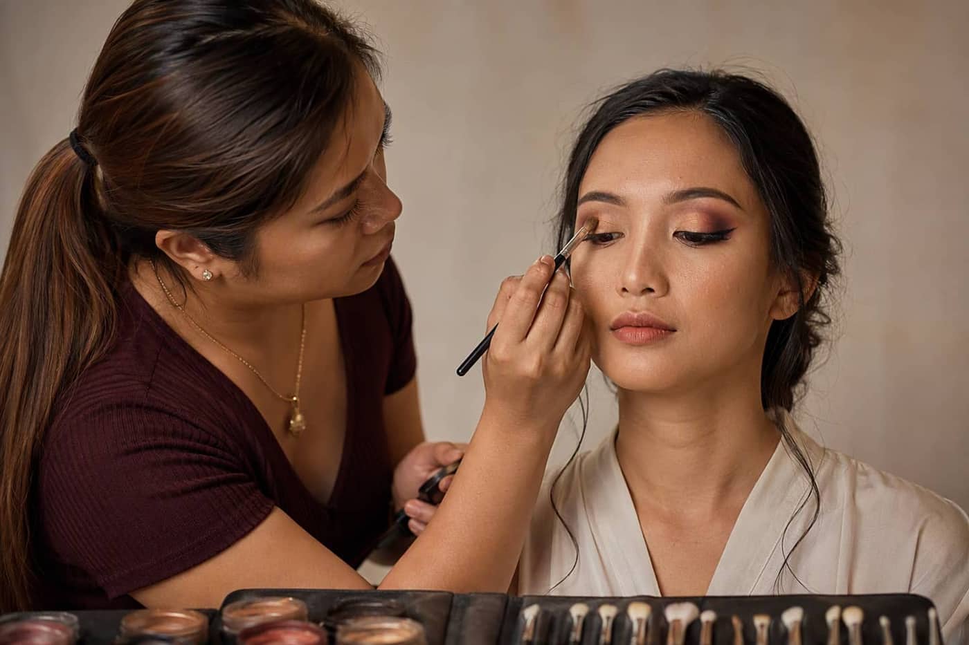 Artist blending eyeshadow on a model at a studio station
